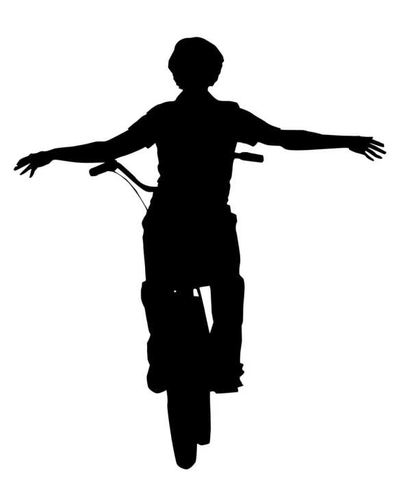 a silhouette of a person riding a bike with arms stretched out