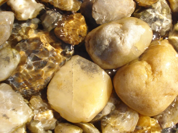 rocks sitting on top of each other and surrounded by sand