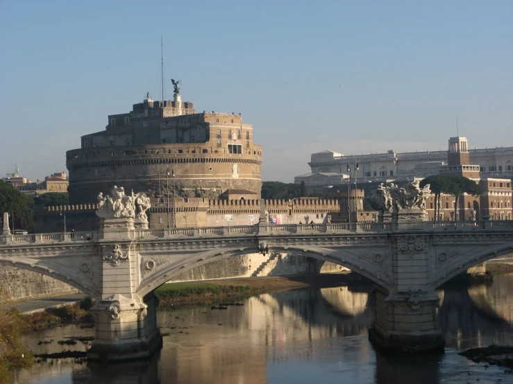 an old bridge with the buildings and statues visible in the background