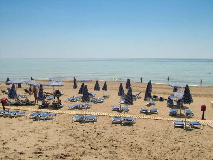 many chairs and umbrellas are on a beach