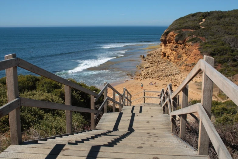 some steps going down to the beach and the ocean