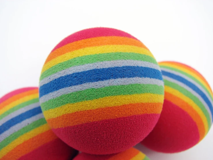 some very colorful balls that are on top of each other