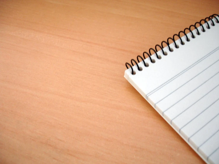 a notepad sitting on top of a wooden desk