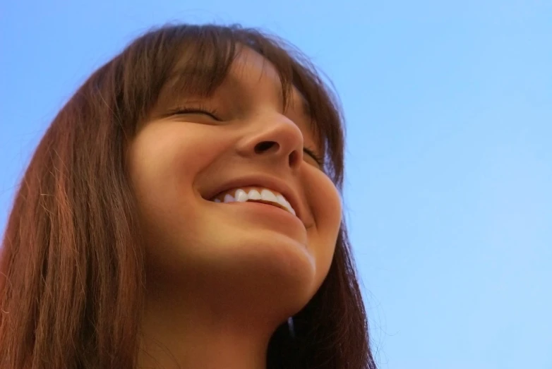 a woman laughing and talking on her cellphone