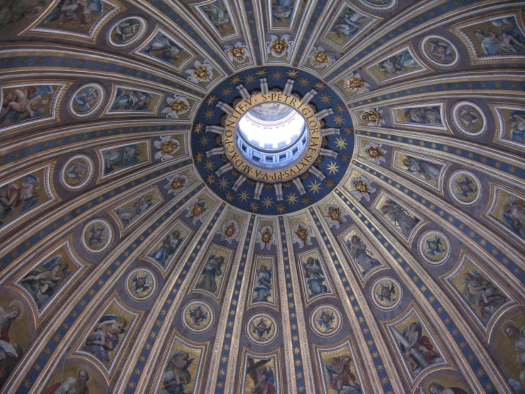 the dome of an ornate building features many paintings