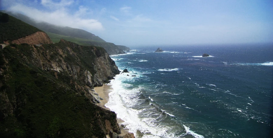 a scenic s of the ocean and a cliff side