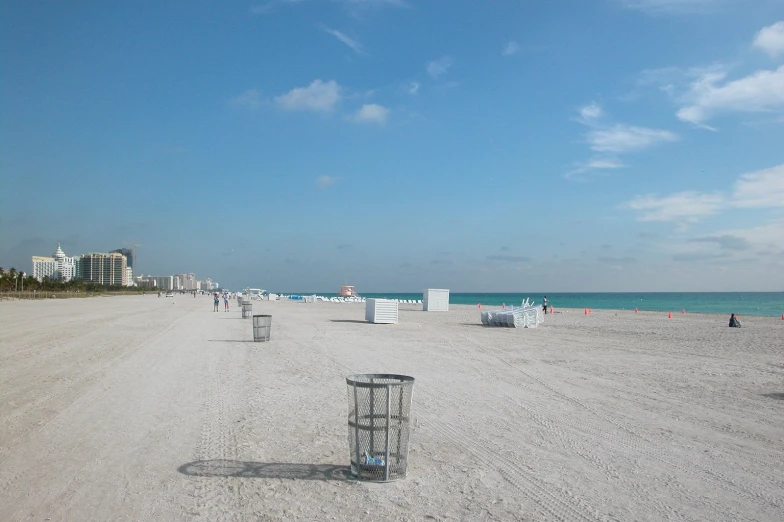 a beach with white sand and water behind it