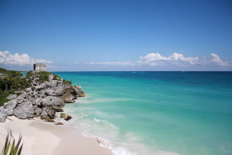 a beach near the shore in clear blue water