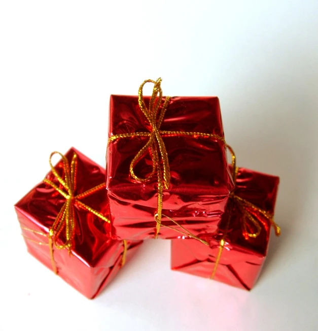 red wrapped gift boxes with golden ribbon and bow