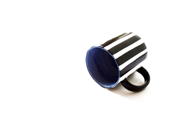 a blue and black striped coffee cup with a black band