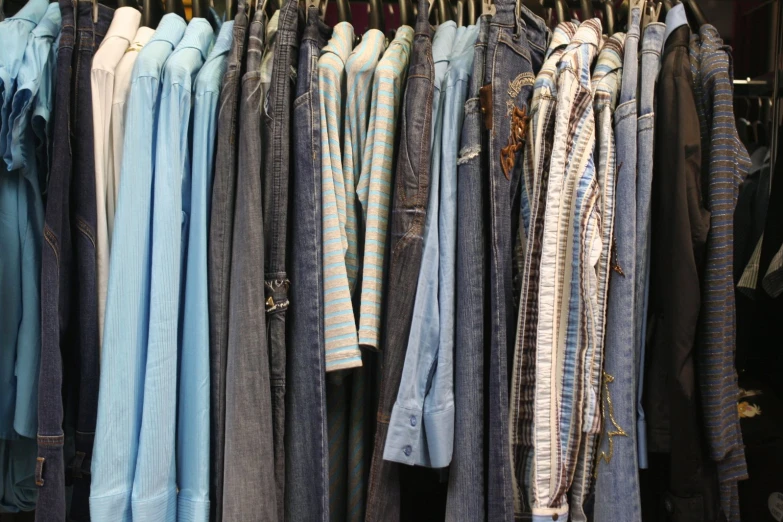 different colored dresses hanging on rack in a store