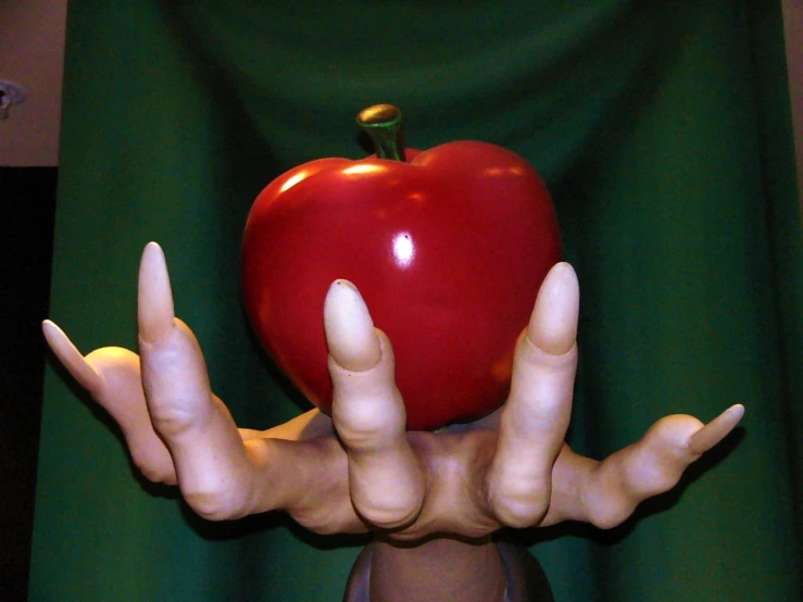 a giant red apple sitting on a table