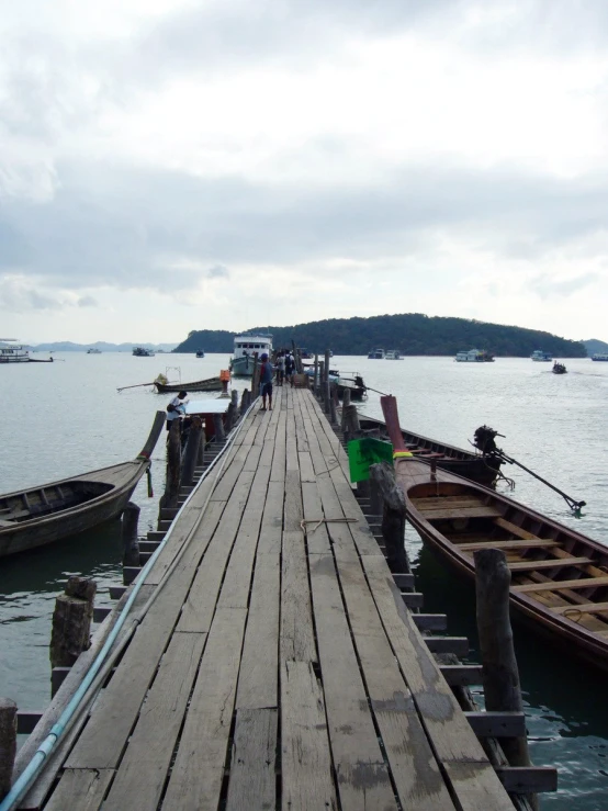 two boats parked at a pier on the water