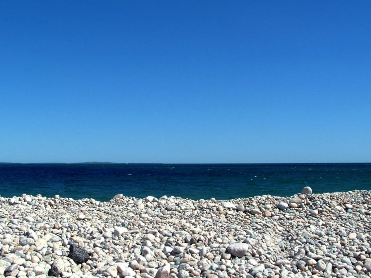 a beach is covered with rocks and water