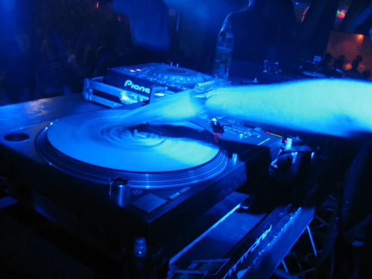 djs are using turntables at a nightclub