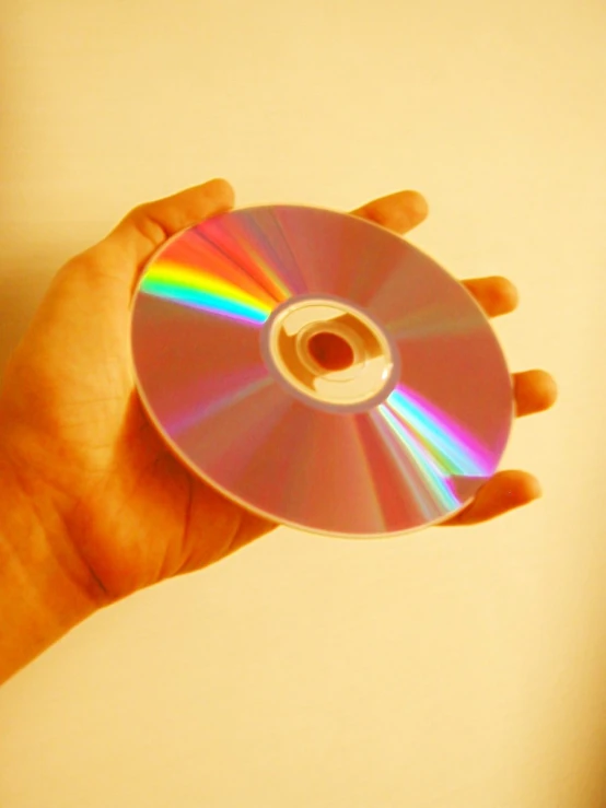 someone holding up a rainbow cd that is not cds