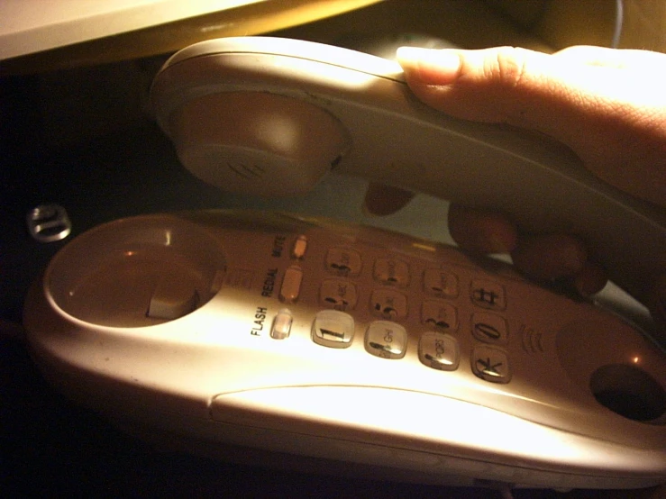 a person holds a computer phone and a remote control