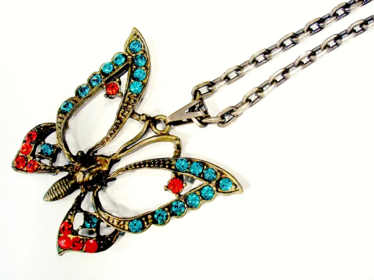 a erfly pendant with multi colored stones on a necklace link