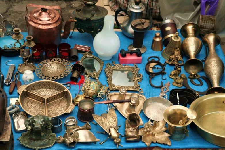 an assortment of old style metal items on a table