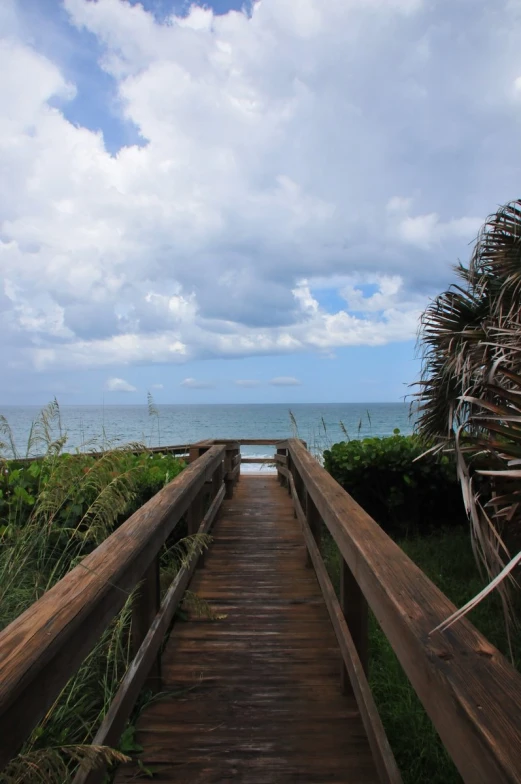 the boardwalk leading to the beach has an ocean view