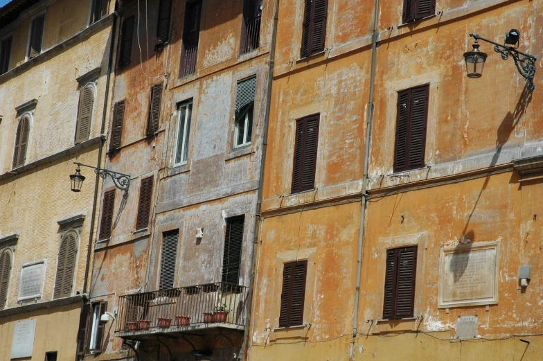 an older building is painted yellow with the sky in the background