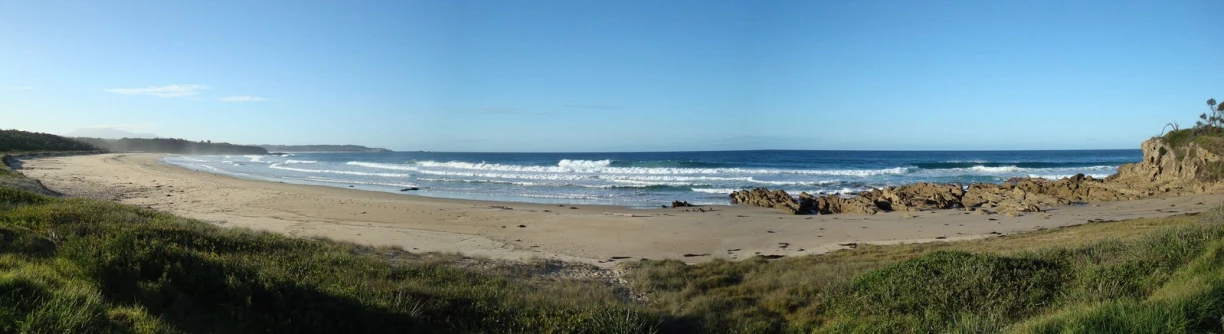 an image of a beach with waves crashing in the background