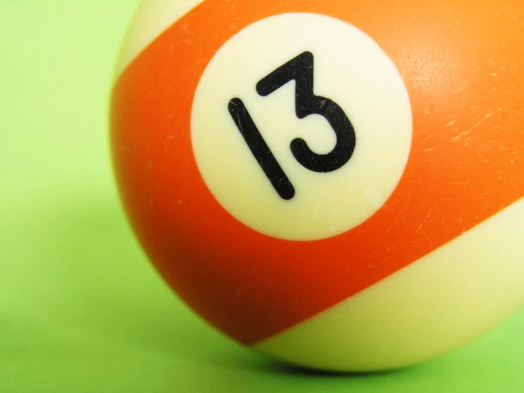 a white and orange pool ball with the number twenty on it