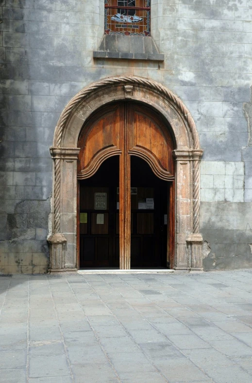 two brown doors and one has a clock