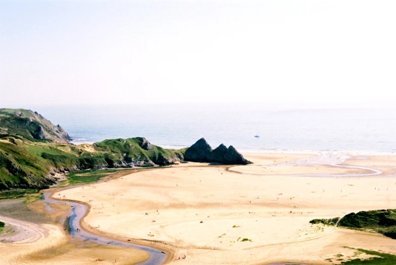 a beach with several large hills near it