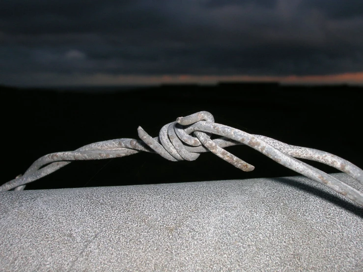 a thin rope with a knot in it on the edge of a large object