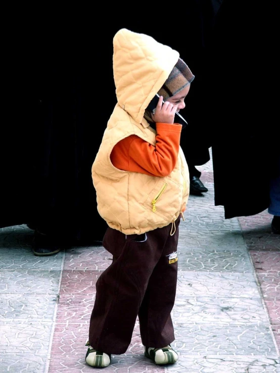 a little  in a big jacket and hat