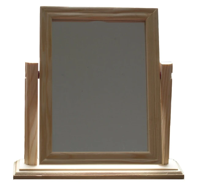 a light colored frame mirror on top of a table