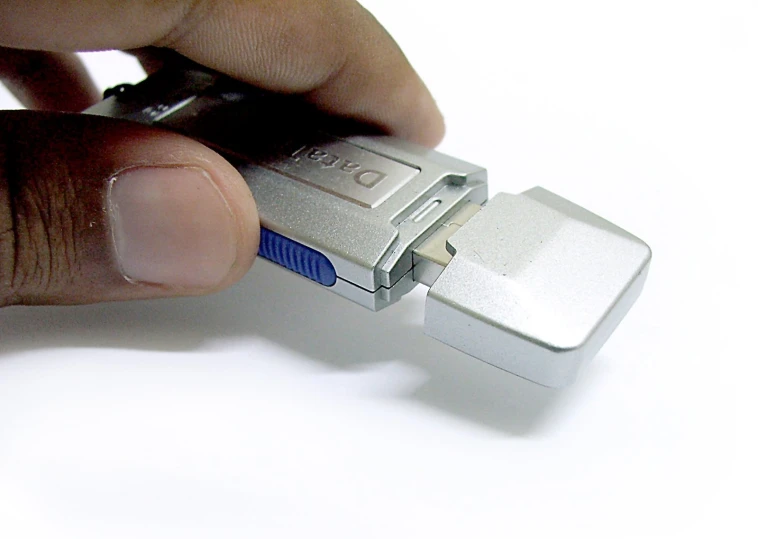 a man holding a usb key to its external mode