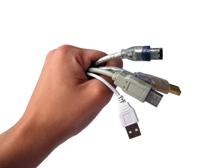 the hand holds a multi - linked usb cable