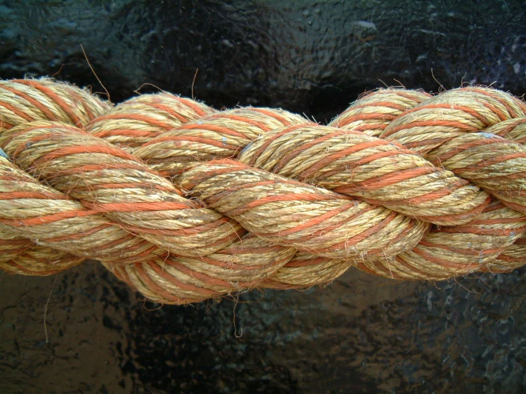 a rope on a fishing boat sitting on a black surface