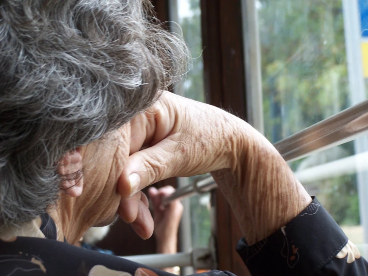 a woman is looking out of an open window