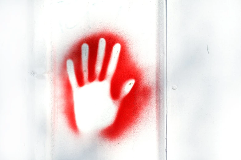 a frosted glass with a white hand that is drawn