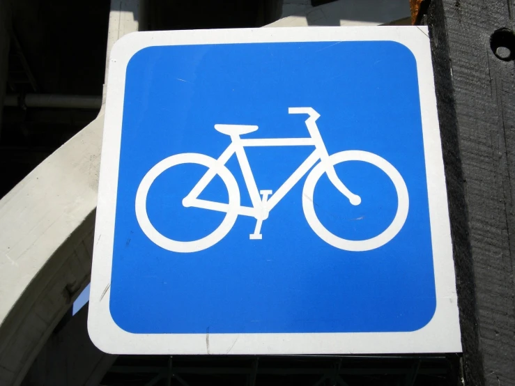 a blue street sign has a bicycle on it