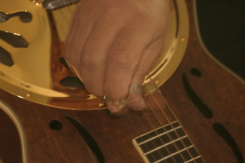 a person's hand holding an electric guitar