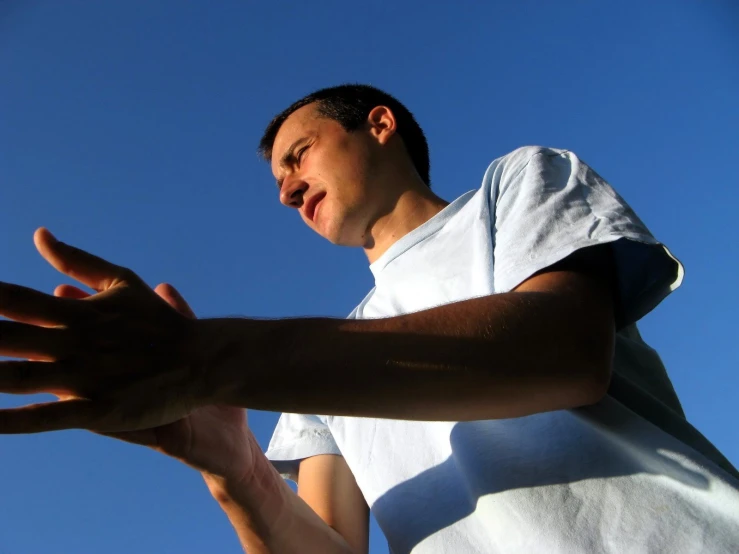 a man with his hand out is staring upwards