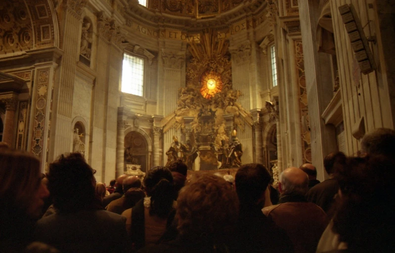 people are gathered around the alter of a church