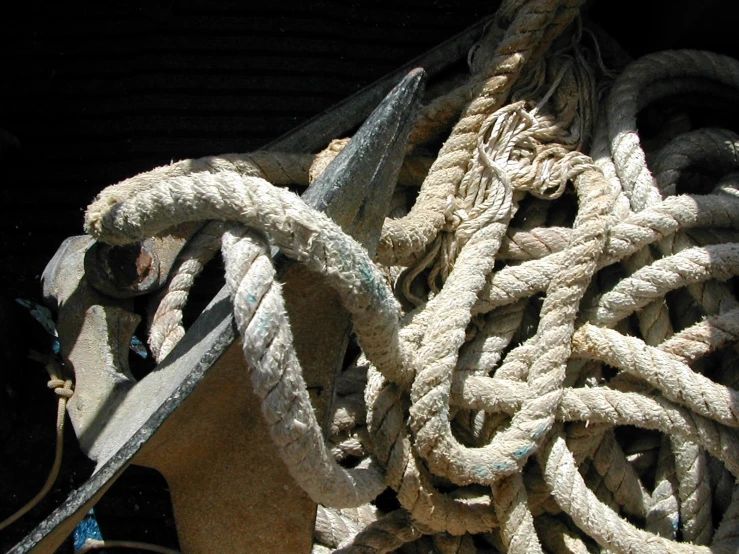 several ropes attached to the wall are stacked