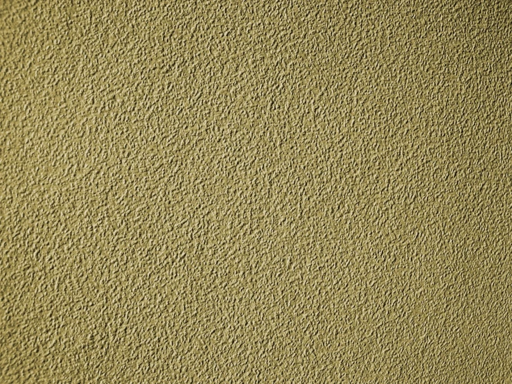 a light green sand beach wall with very small scratches