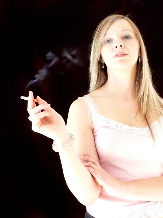 a lady is smoking an electronic cigarette