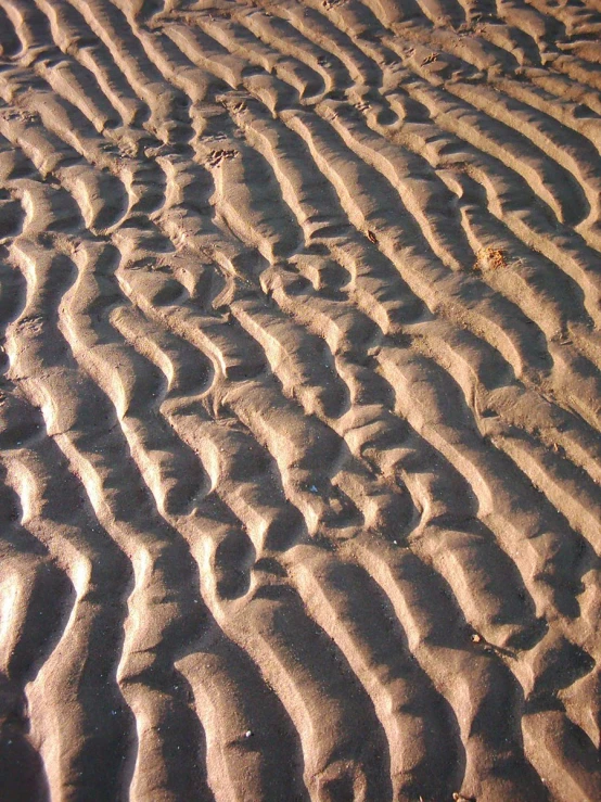 there is sand with waves going through it