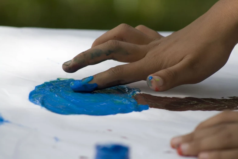 a child doing soing with finger paints on it