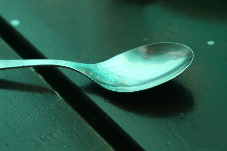 a spoon is shown on the green table