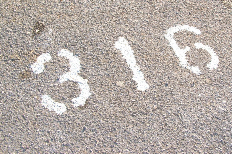 white numbers are shown in the street next to the sidewalk