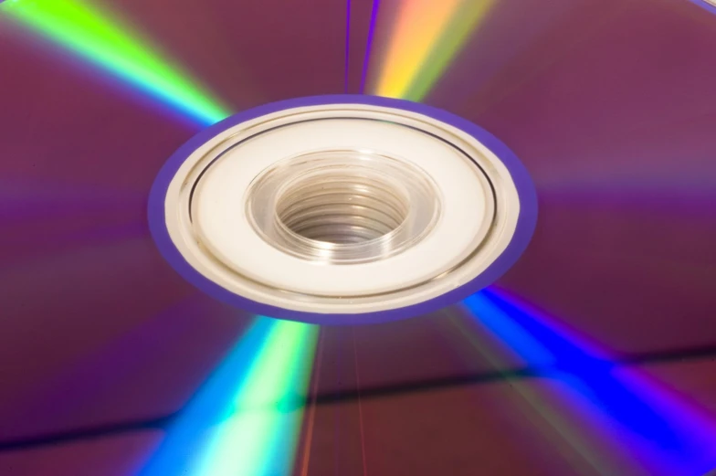 a cds disc with several colors of light on top