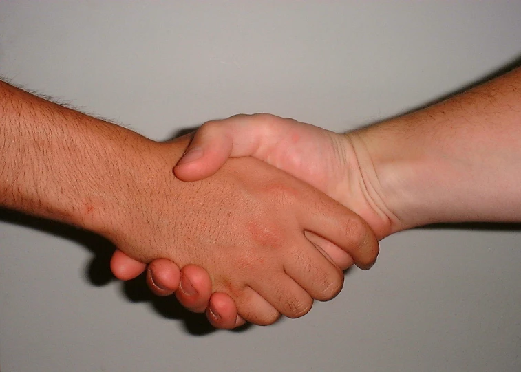 a close up of two hands reaching each other